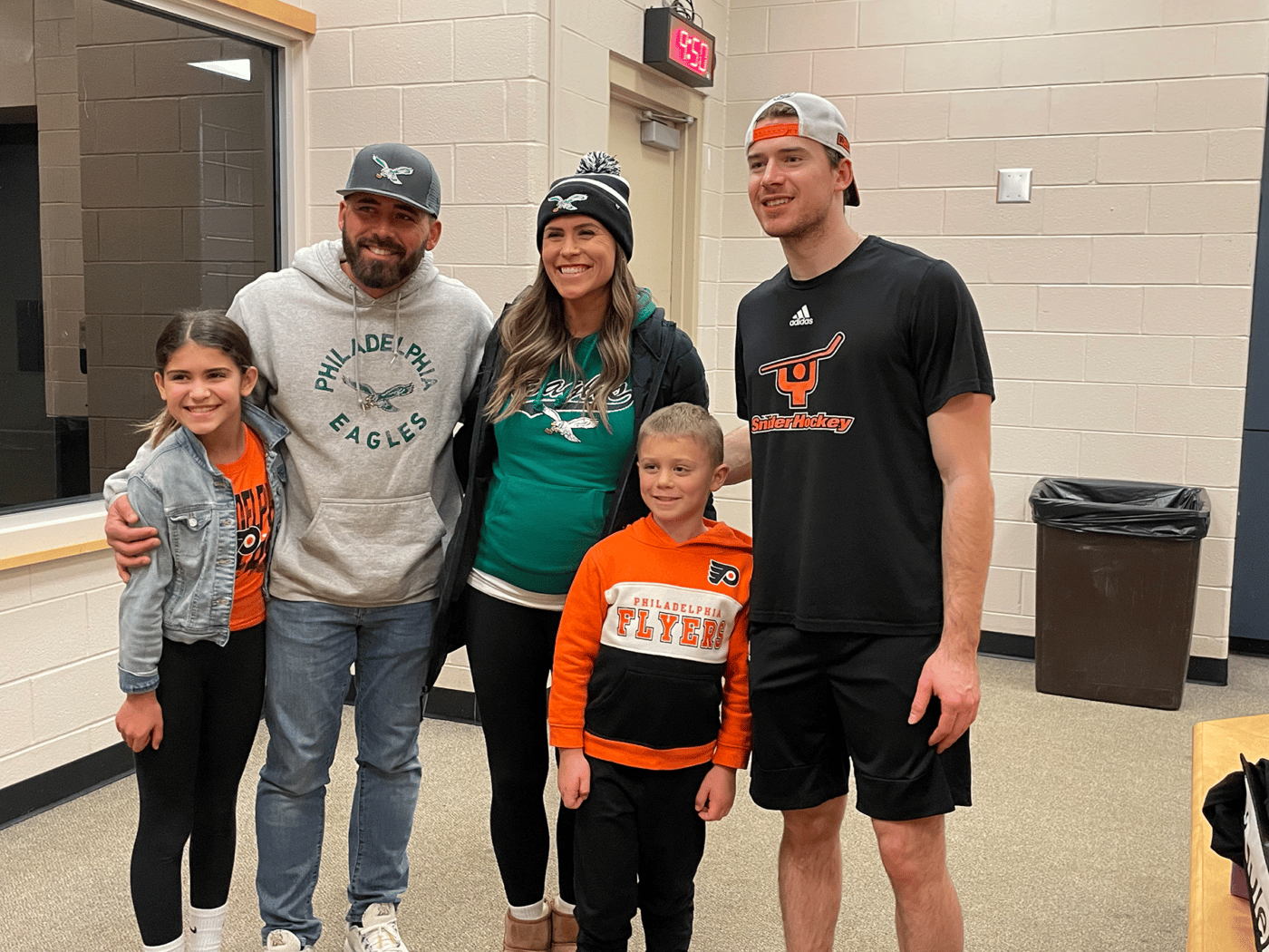 The Gettler family posing for a picture with Flyers Goalie, Carter Hart.